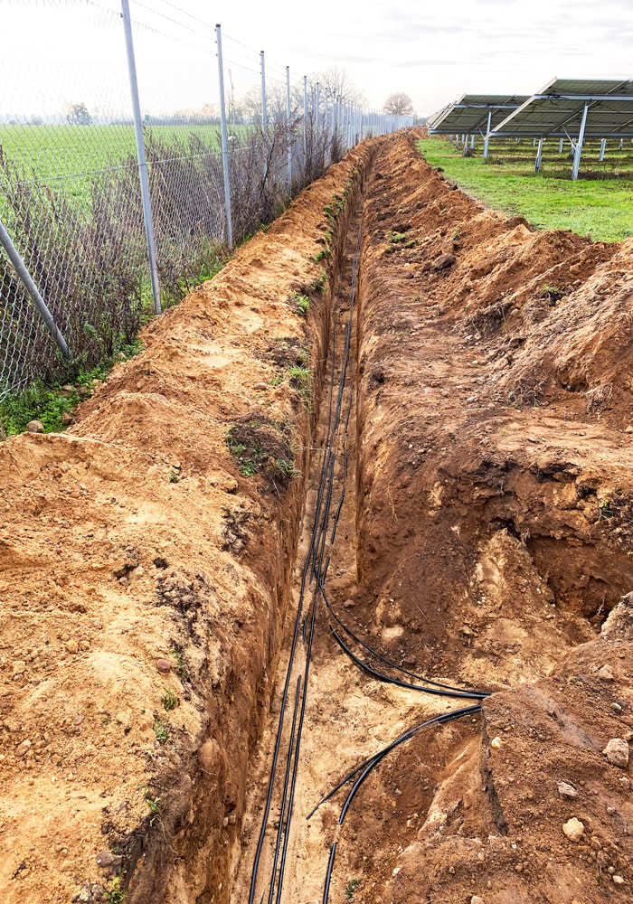 New construction of safety technology on a solar park: construction of a cable trench with line marking